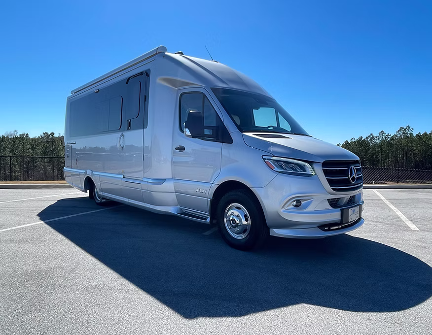 Silver motorhome parked on pavement