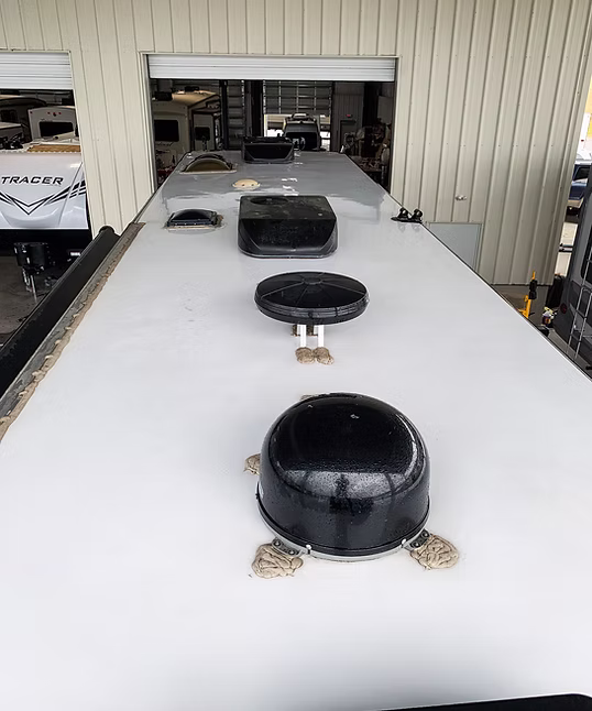 White RV roof with vents outside the shop